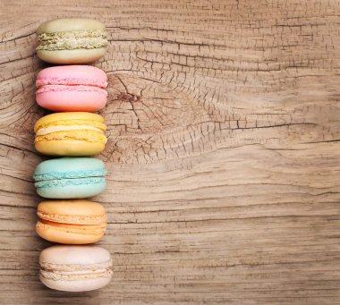 Colorful French Macarons on wooden background
