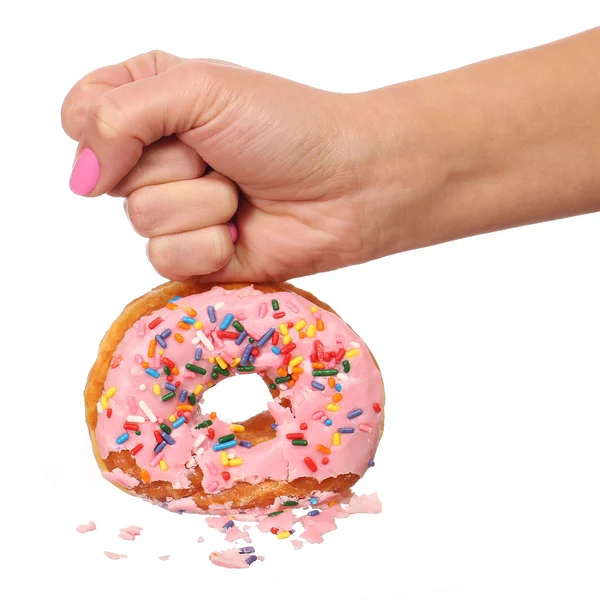 Woman Hand Smashing Donut with Sprinkles isolated — Stock Photo, Image