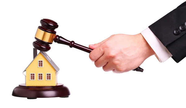 Concept of house sale with gavel in hand, isolated on white — Stock Photo, Image
