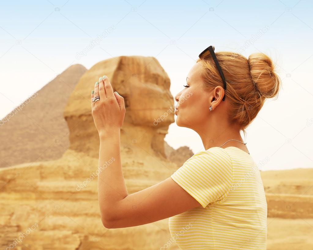 Tourist kissing the Sphinx, Cairo, Egypt. Kiss of the Sphinx