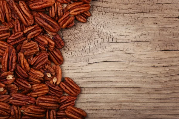Pecan nuts on old wooden background. Top view — Stock Photo, Image