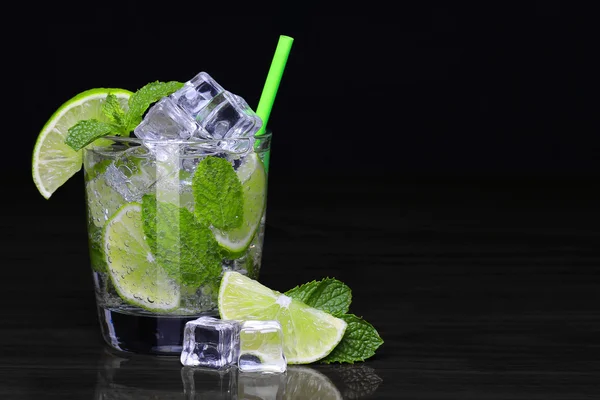 Mojito cocktail in glass with mint over black background — Stock Photo, Image