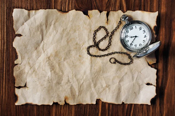 Sheet of ancient parchment and pocket watch — Stock Photo, Image