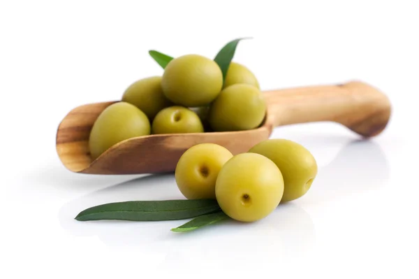 Green olives in wooden scoop — Stock Photo, Image
