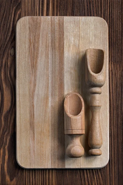 Wooden kitchen utensils on a wooden table, top view — Stock Photo, Image