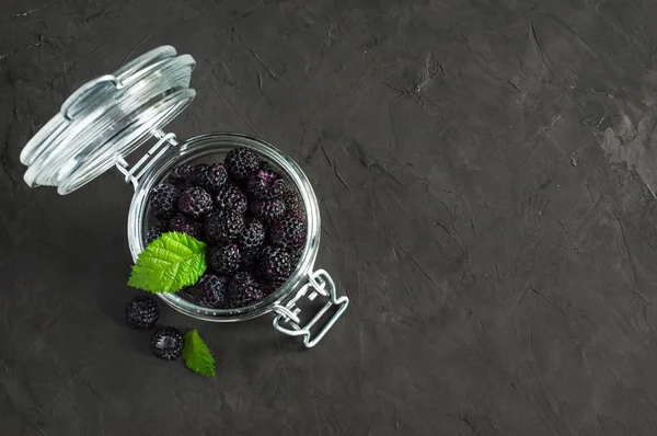 Black raspberry or blackberry in glass jar