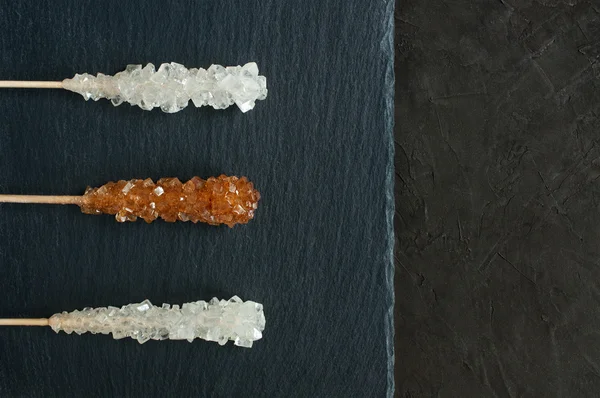 Candy brown and white sugar on a sticks