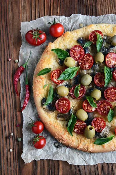 Mushroom pizza with cherry tomatoes and basil