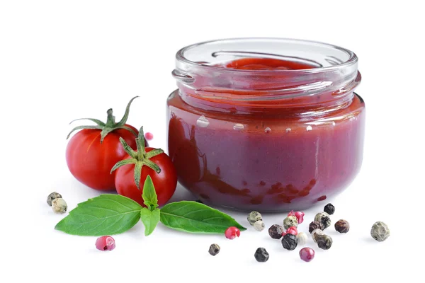 Tomato sauce and basil in glass jars — Stock Photo, Image