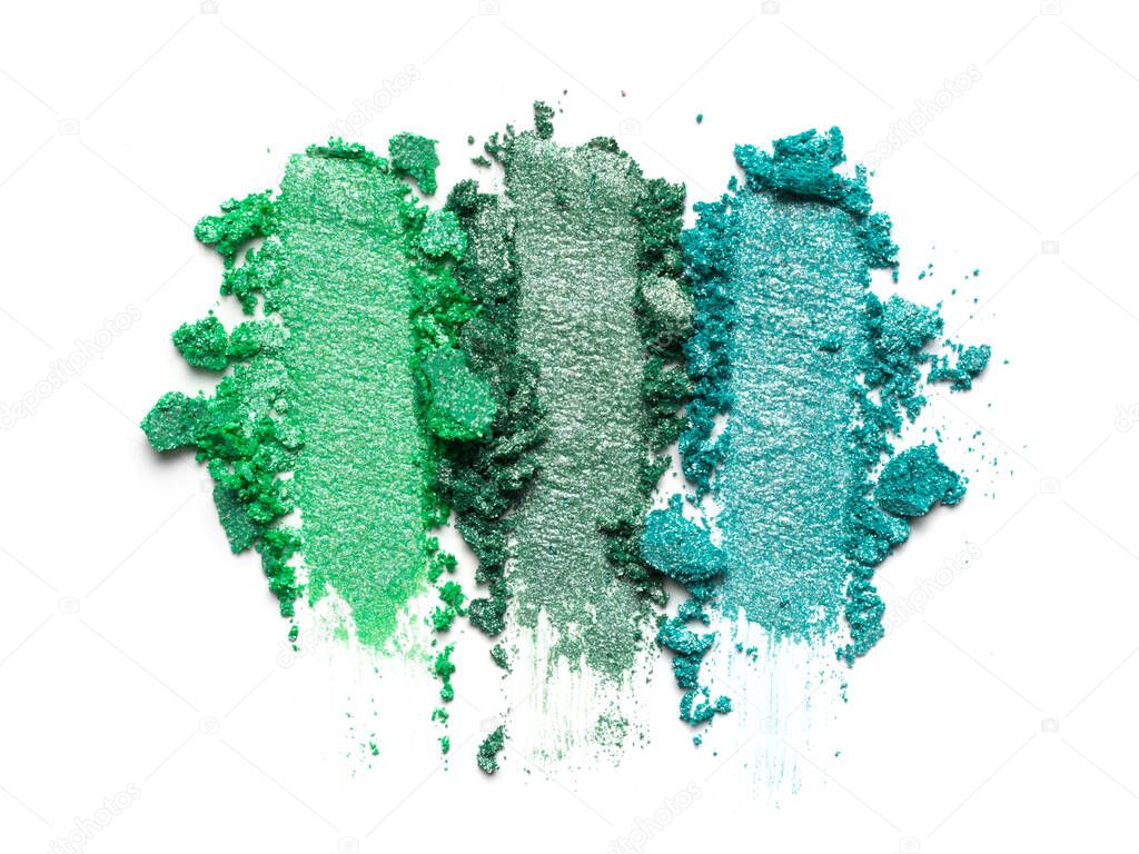 Flat lay of brush strokes. Broken bright color eyeshadow as samples of cosmetic beauty products isolated on white background
