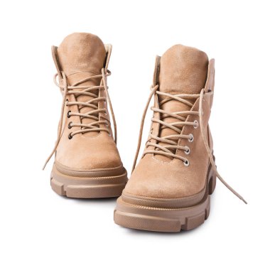 Tabanında sert ayak izleri olan moda ayakkabıları. Beyaz arka planda izole edilmiş sokak tarzı için bağcıklı bej deri çizmeler