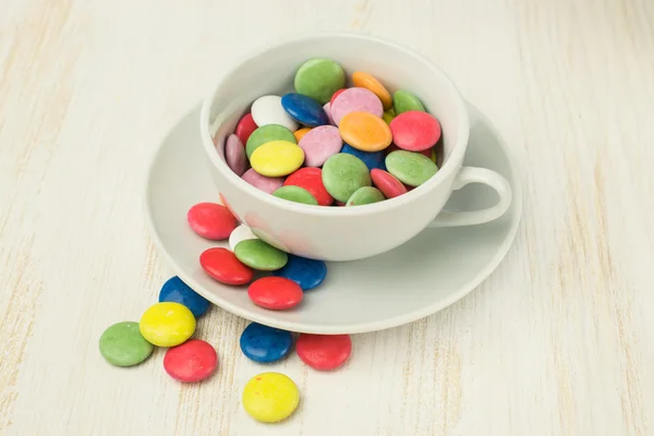 Colorful candies in a white cup — Stock Photo, Image