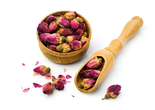 Brotes de rosas secas para el té en un tazón de madera —  Fotos de Stock