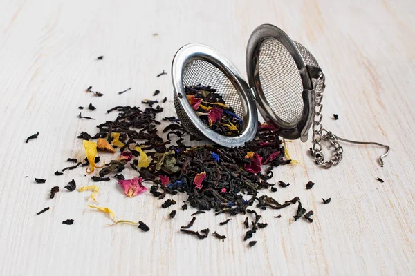 Herbal tea and tea strainer — Stock Photo, Image