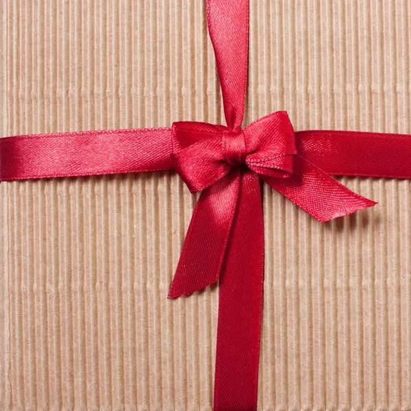 Gift carton wrapped red ribbon with bow, top view Royalty Free Stock Photos