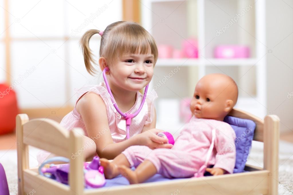babies playing with baby dolls
