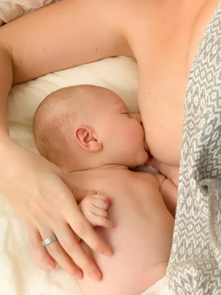 Closeup breastfeeding in bed Royalty Free Stock Photos