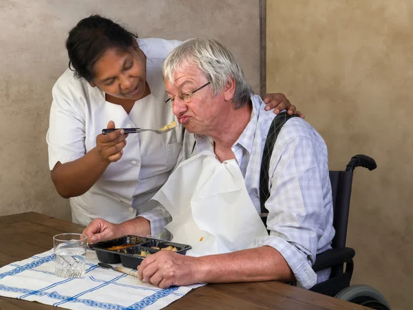 Feeding elderly man — Stock Photo, Image