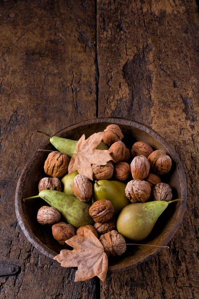 Autumn bowl with pears and walnuts — Stock Photo, Image