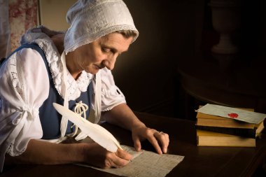 Rembrandt tarzı ya da Rönesans portresi tüy kalemiyle mektup yazan bir kadın.