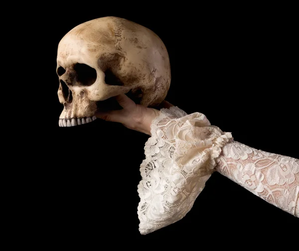 Hand presenting creepy skull — Stock Photo, Image