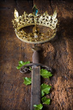 Rusty sword and golden crown clipart