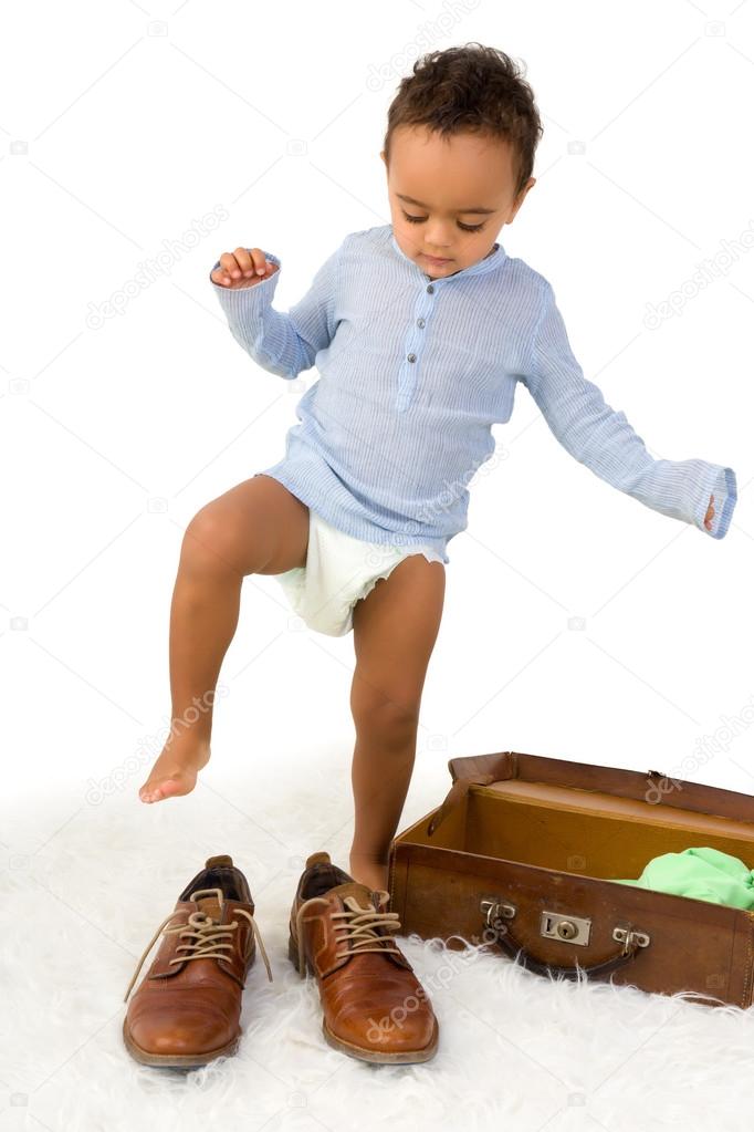 Toddler trying Dad's shoes