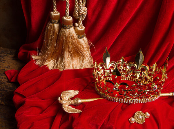 Scepter and crown on red velvet