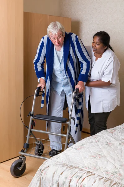 Nurse helping with rollator — Stock Photo, Image