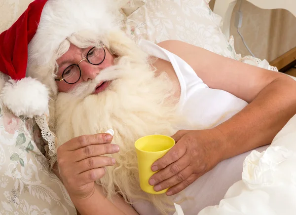 Santa Claus taking medicine — Stock Photo, Image