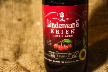 Antwerp, Belgium, December 2020: Illustrative Editorial: Lindemans Kriek Belgian speciality beer. Selective focus. Textured background clipart