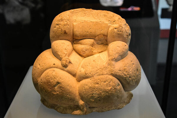 A carved stone figure of a fat lady at Hagar Qim Visitor Centre, Malta