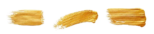 Altın boya fırçaları. Beyaz arkaplanda altın renk lekeleri