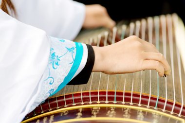 Girl playing classical Chinese instruments clipart