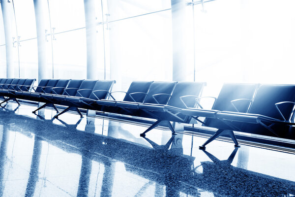 Airport lounges, benches and large windows.