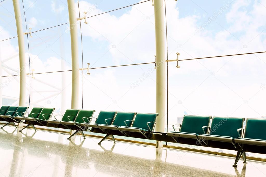 Airport lounges, benches and large windows.