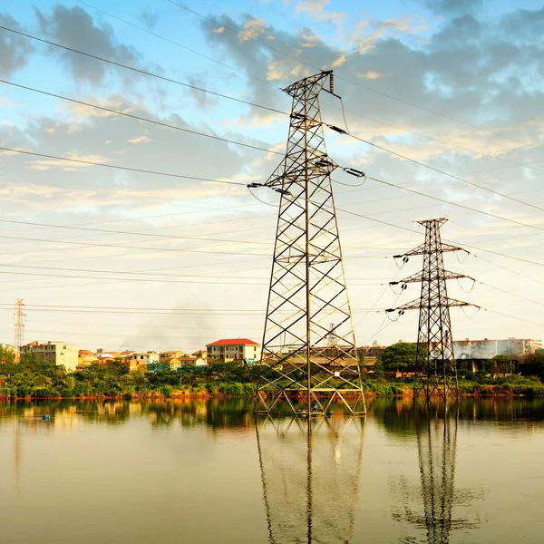 High voltage tower and reflection in water — Stock Photo, Image