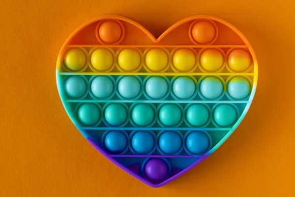 Color Pop Antistress Toy Children Rainbow Heart Shaped Orange Background — Stock Photo, Image