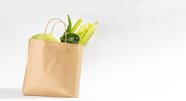 Delivery healthy food background. Vegan vegetarian food in craft paper bag.Grocery shopping food supermarket and clean eating concept