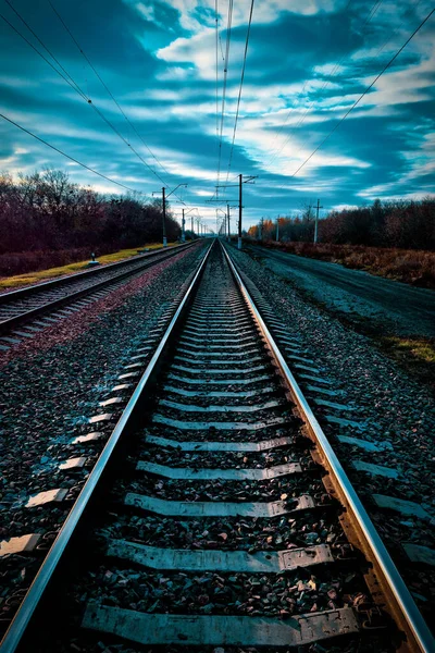 railway, rails and sleepers without trains close-up, on a beautiful sunset overcast sky