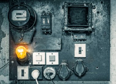 Duvarda yanan parlak bir ampul, Dünya 'da elektriğe saygı, ön plan ve arka plan bokeh etkisi ile bulanıklaşır.