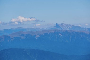 Oshten Dağı 'nın tepesinden Kafkasya Dağları' nın uzak dağlarına mavi bir sis bulutu içinde.
