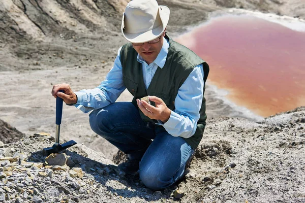 Άνθρωπος Γεωλόγος Μια Περιοχή Της Ερήμου Εξετάζει Ένα Δείγμα Βράχου — Φωτογραφία Αρχείου