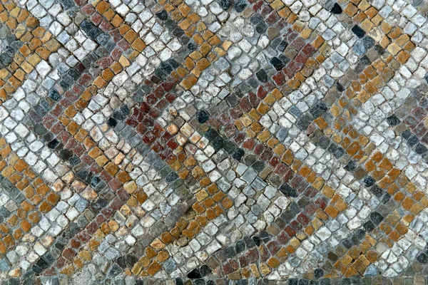 background - fragment of antique mosaic floor with a pattern of tiles