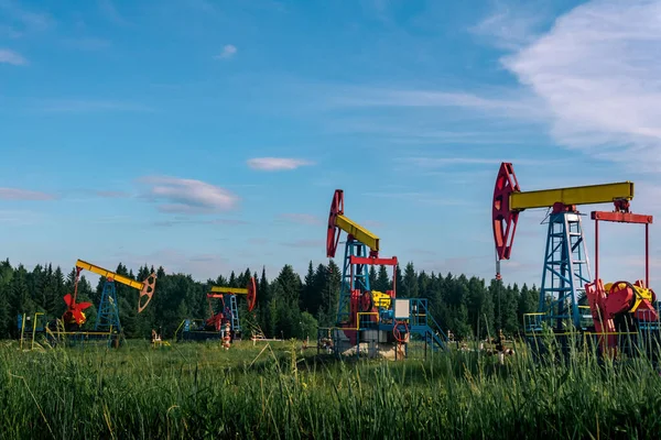 oil pumping stations pumpjacks in a clearing in the forest