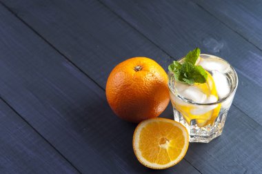 Ahşap arka plan Portakal dilim, nane ve buz küpleri ile taze alkolsüz kokteyl