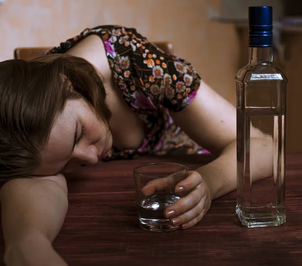 Részeg nő tartja őt alkoholos ital és alvás az asztalon — Stock Fotó