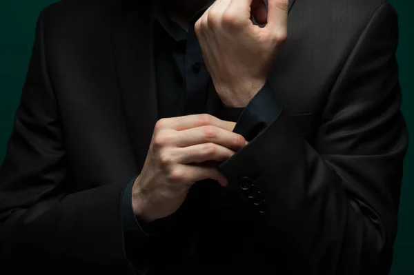 Close-up portrait of a handsome self-confident man in a red shirt and bow tie with glasses posing on a pale green background. The concept of gallant intelligent men — Stock Photo, Image