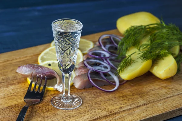 Glass of vodka, herring, red onion and potatoes — Stock Photo, Image