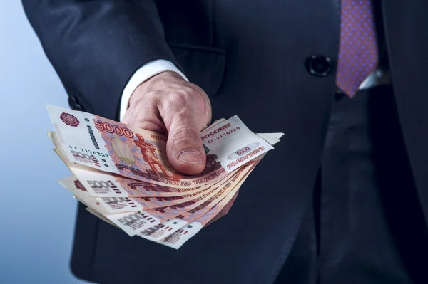 Man in a suit holds Russian rubles — Stock Photo, Image